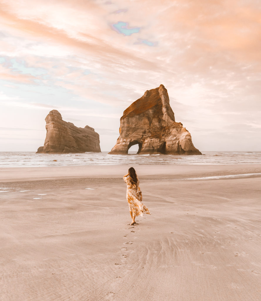 New Zealand Travel Guide | Woman walking on Wharaiki Beach near Abel Tasman in New Zealand