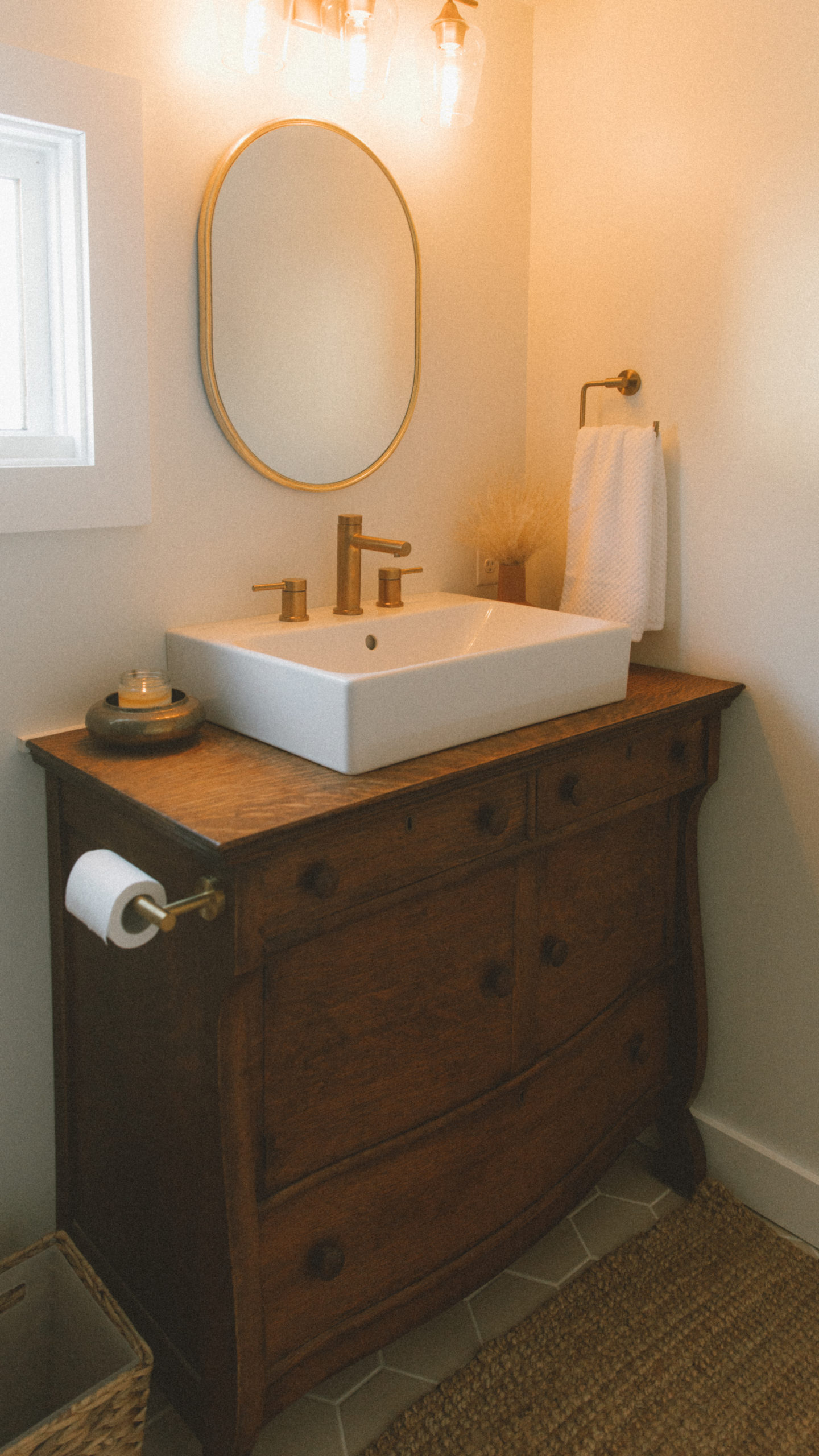Vintage dresser turned bathroom vanity in a sustainable, earth-inspired bathroom renovation via elanaloo.com